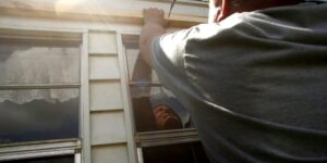 bradenton-fl---september-08--evan-corley-works-to-install-plywood-over-his-homes-windows-as-resid
